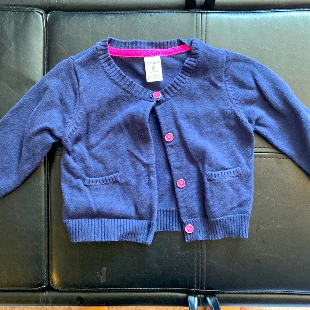 Navy blue sweater with pink buttons
